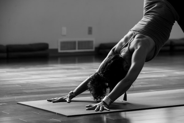 Students holding Trikonasana during a hatha yoga class in Mansarovar, Jaipur
